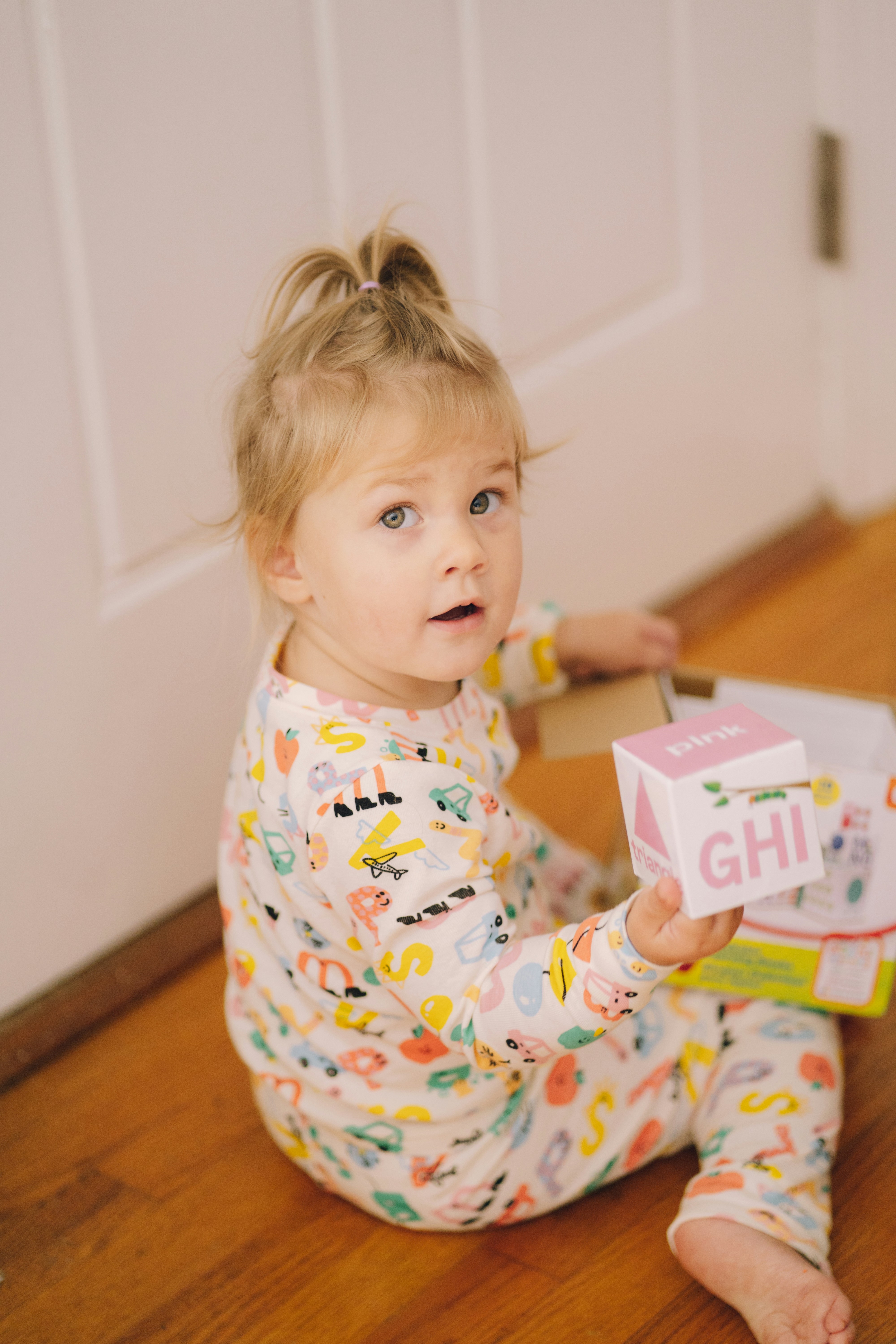 Sunday morning playtime by Learning Game a baby holding a toy